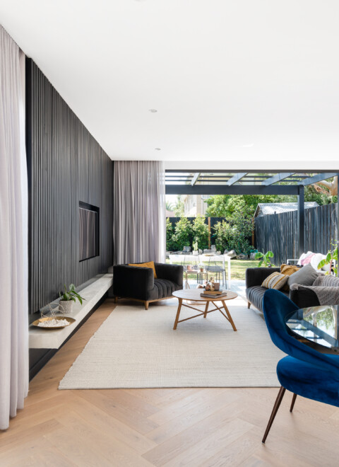 Contemporary living and dining space with herringbone timber flooring