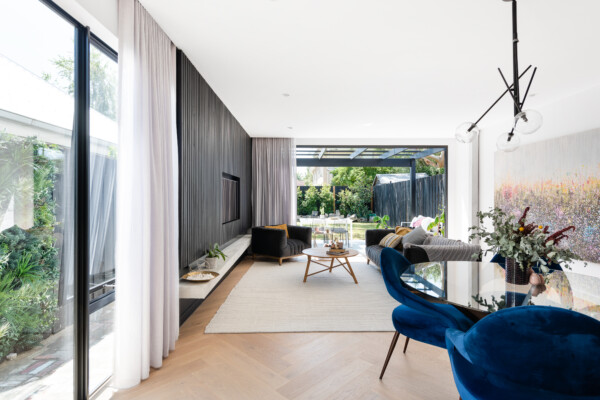 Contemporary living and dining space with herringbone timber flooring