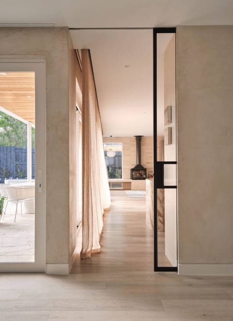 Plank timber flooring in Kustom Timber’s Storm finish, featured in a light-filled hallway at Hinkler House.