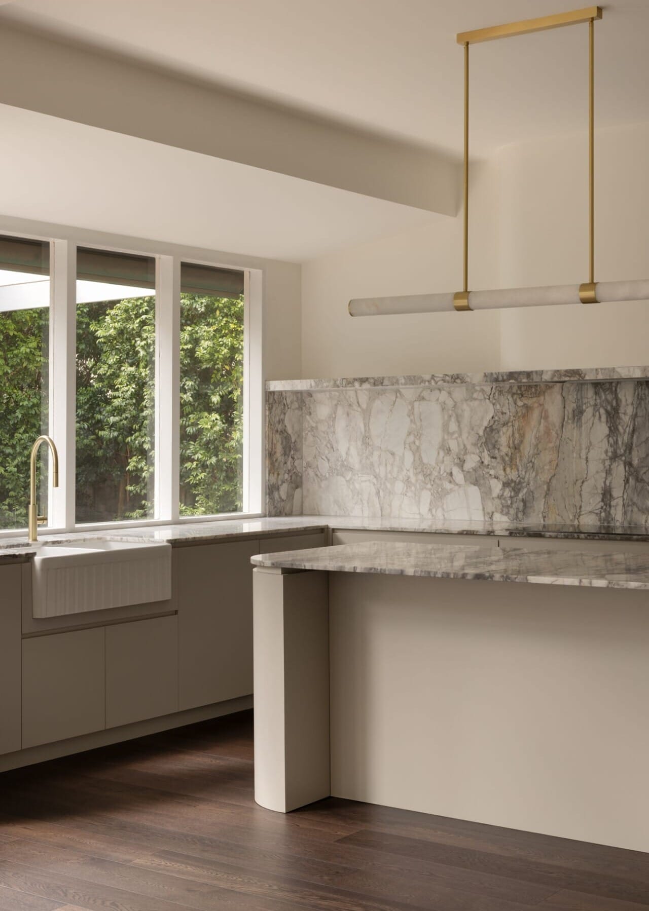 Marble kitchen sink and benchtop framed by windows and a hanging pendant light, Black Japan 190mm timber flooring in the foreground.