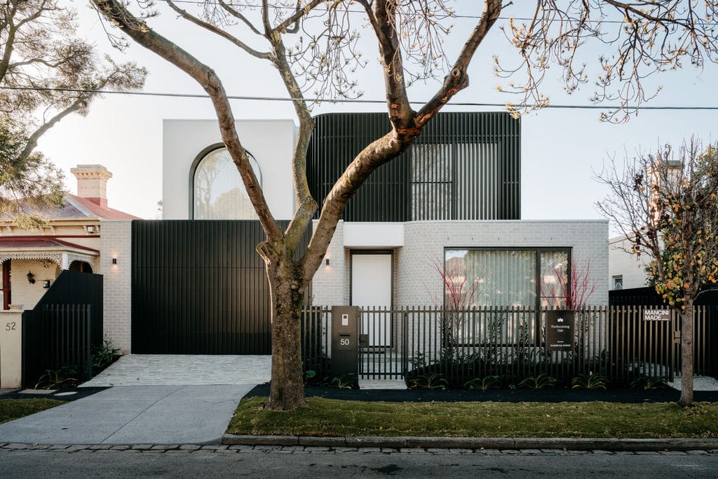 Street frontage at Perth Street with charcoal vertical battens and soft grey brickwork