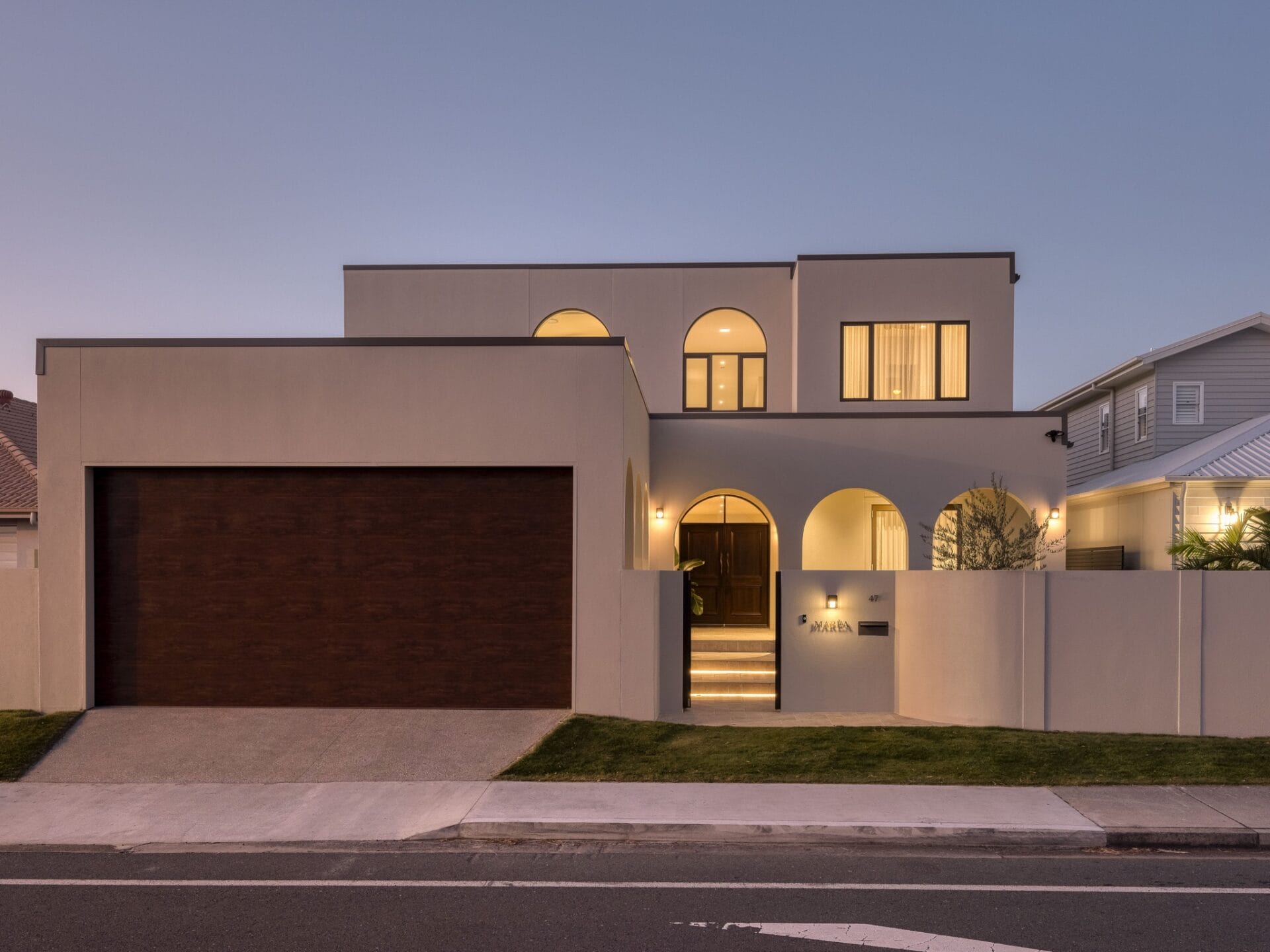 MARÈA's arched front façade lit at dusk on Markeri Street, Mermaid Waters