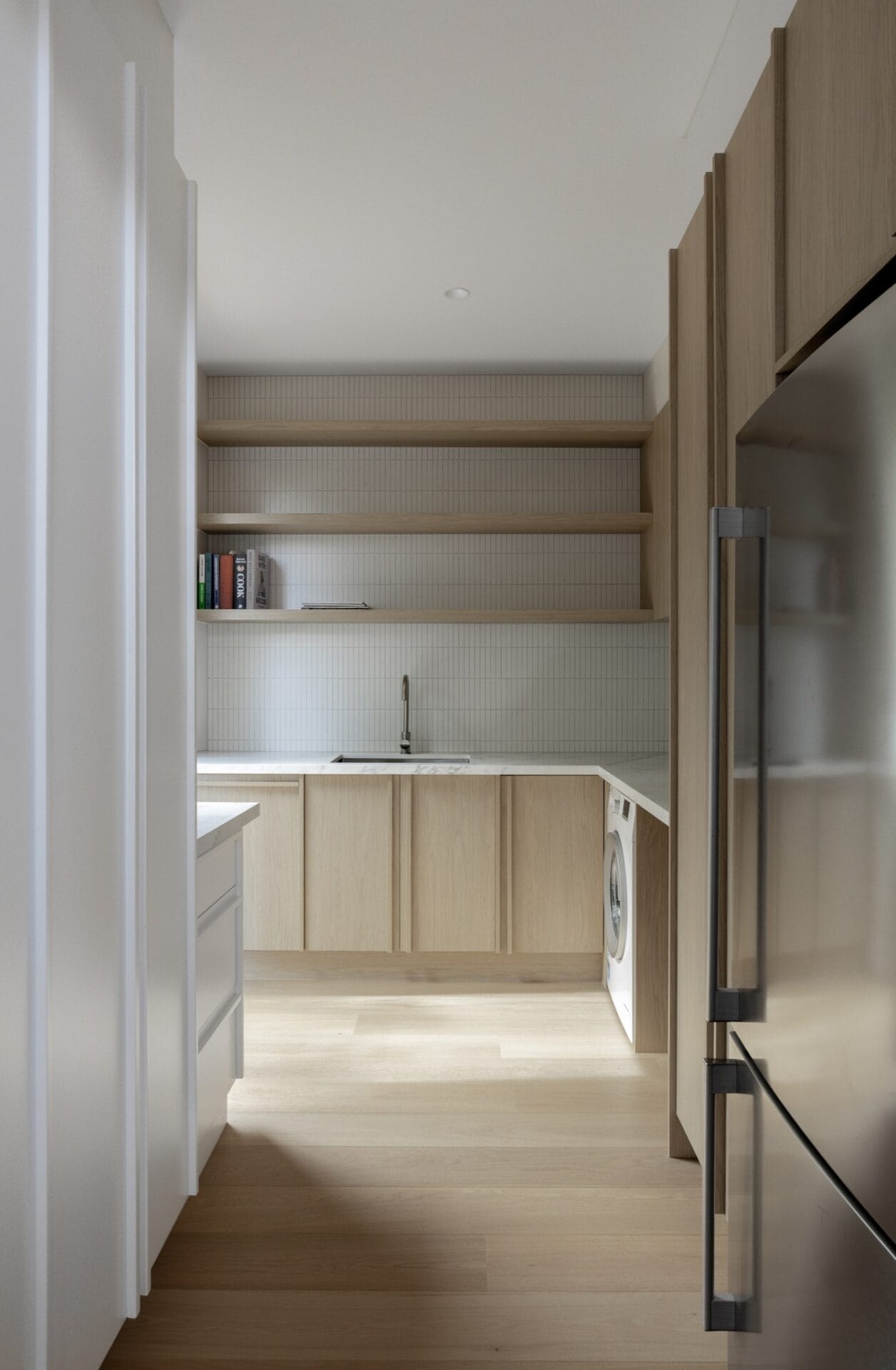 Timber shelving and joinery in the butler's pantry, picking up the tone of the flooring