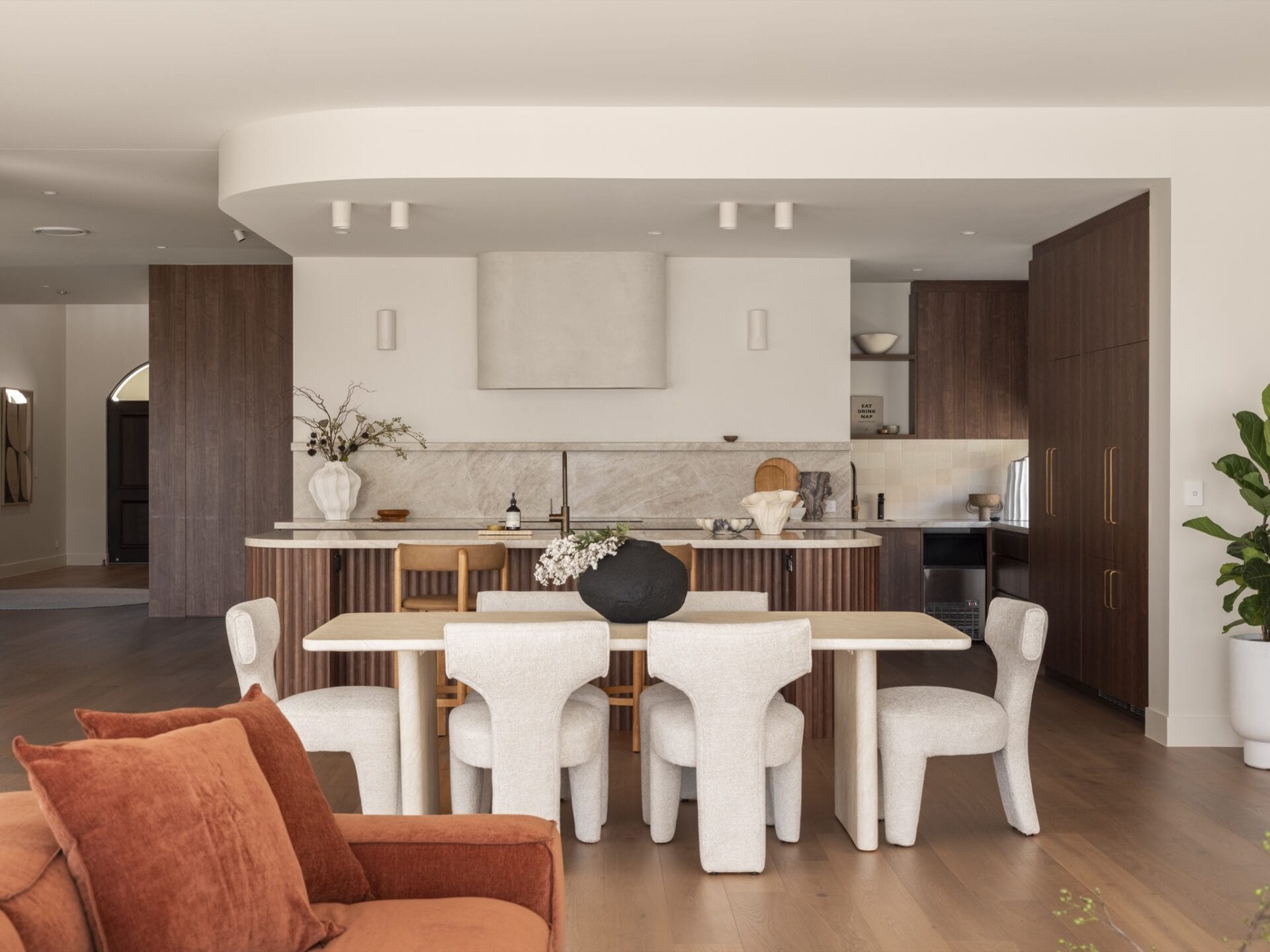Open-plan kitchen and dining at MARÈA with fluted walnut island and Dakar oak floor