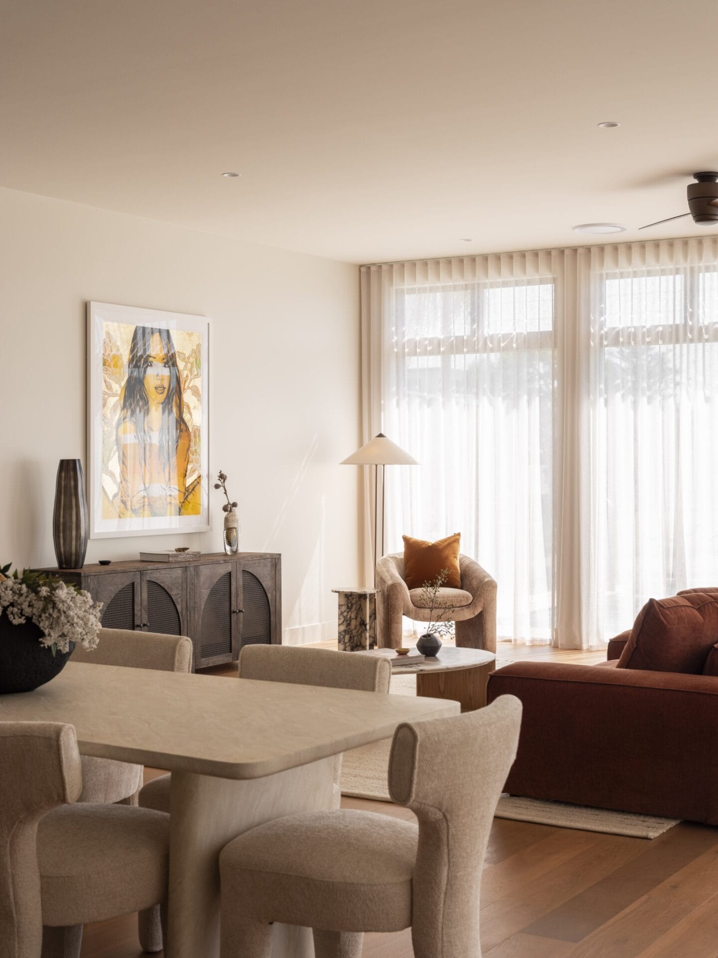 Dining area with sculptural chairs and artwork beside the lounge at MARÈA