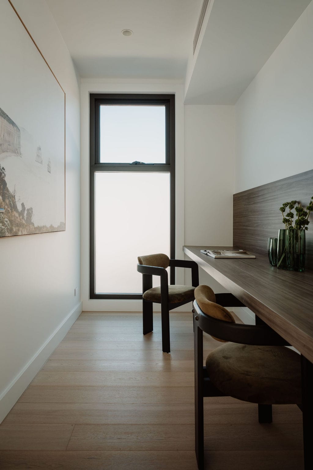 Black-framed window framing planting on a compact inner-suburban site