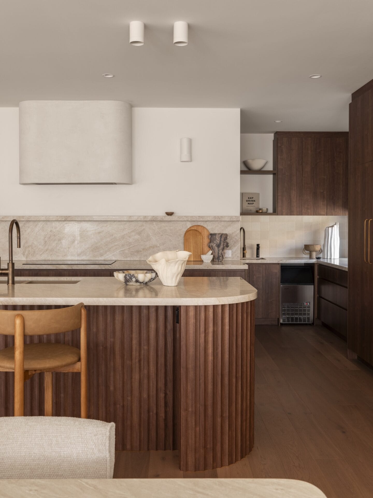 Kitchen at MARÈA with Taj Mahal stone benchtop and fluted walnut island