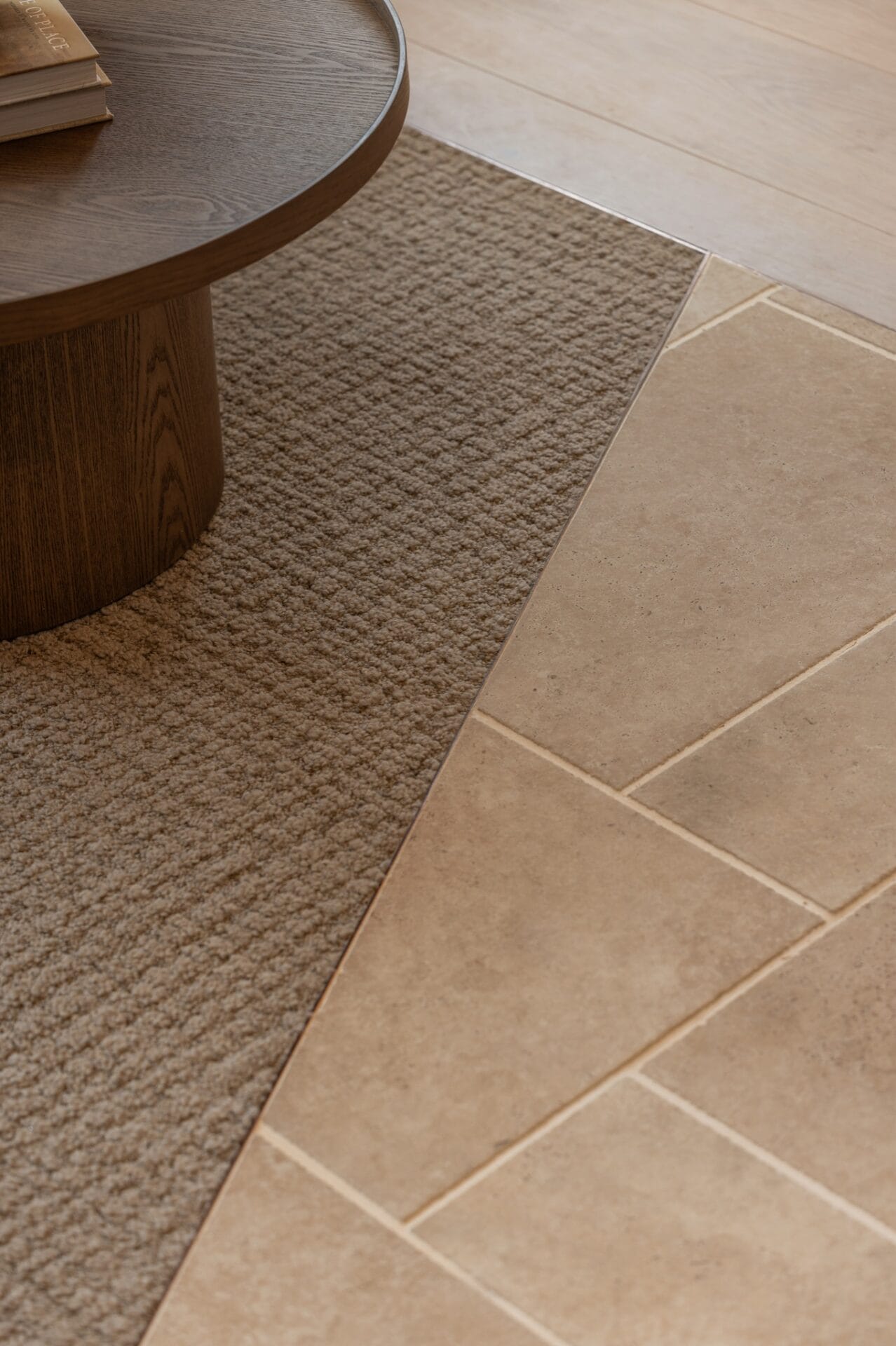 Alta 260mm timber floorboards meeting a woven rug beneath a round timber table base