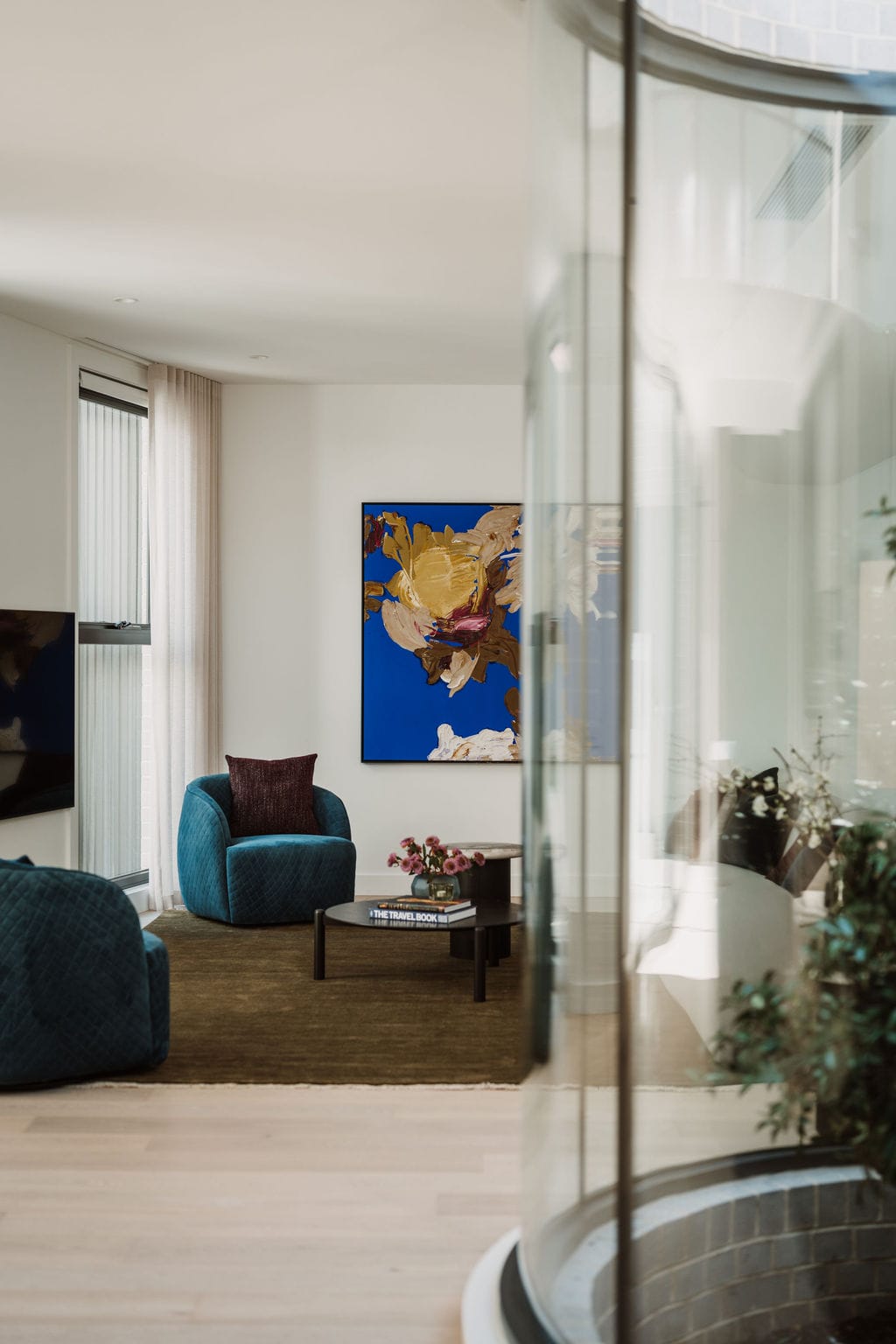 Alta timber flooring running through the living area beneath sheer curtains