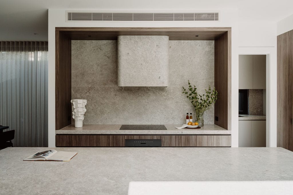 Screen set into timber joinery, flanked by vases and planting