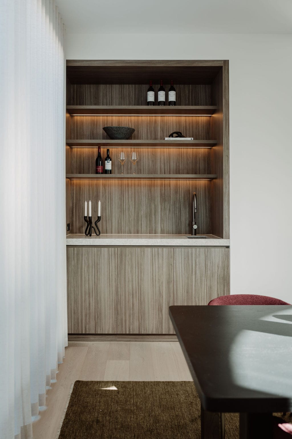 Styled object sitting on warm timber joinery