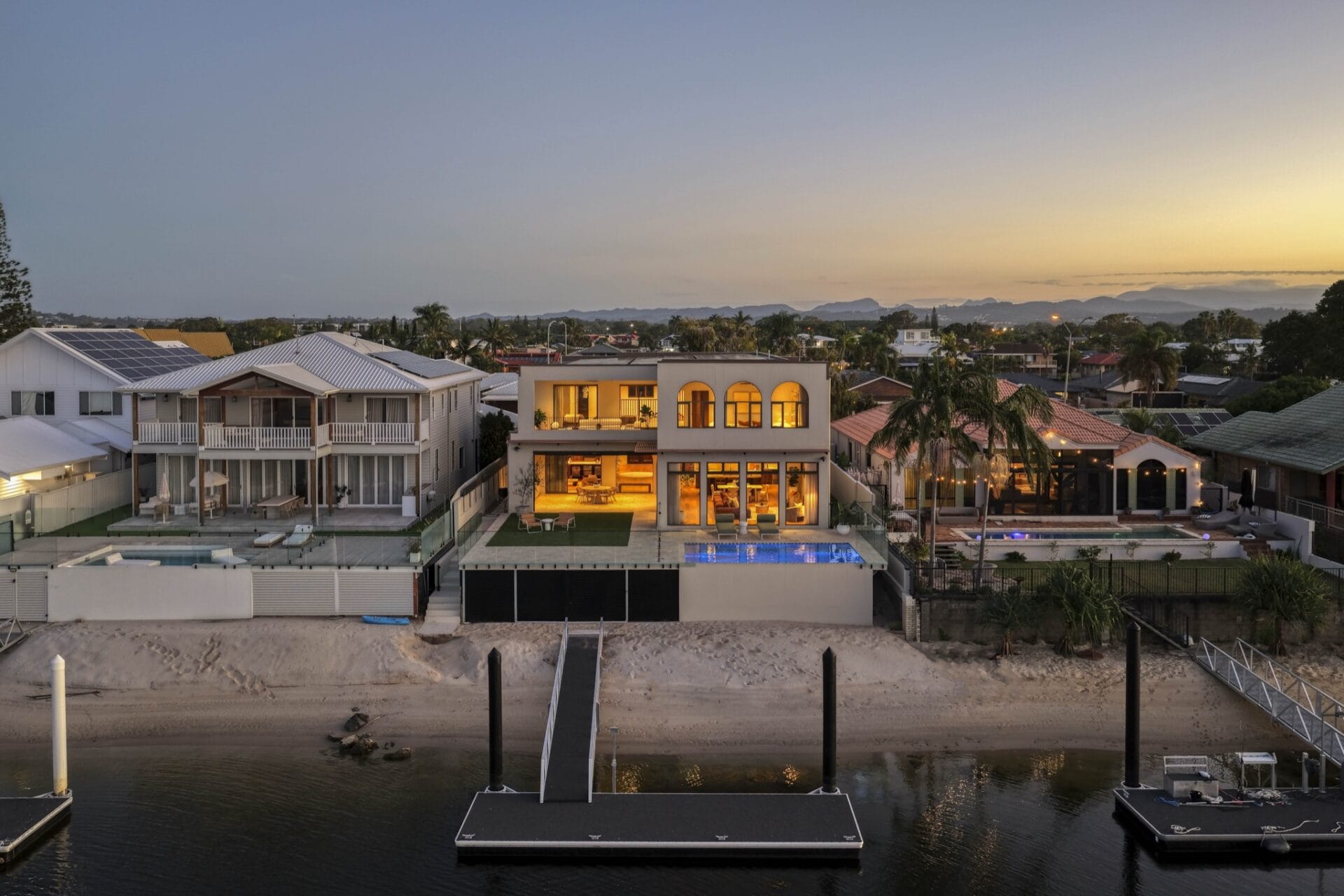 Aerial view over Mermaid Waters canals at sunset with MARÈA on the waterfront